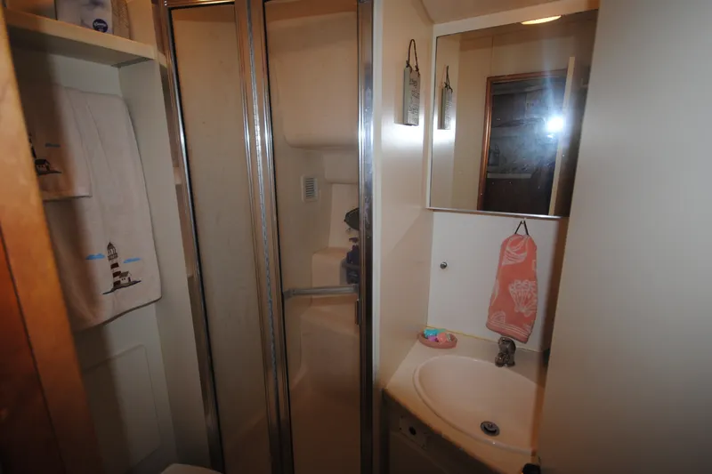 Slide: The Image of Bathroom interior of 2000 Silverton 351 Sedan yacht with shower and sink. - 23
