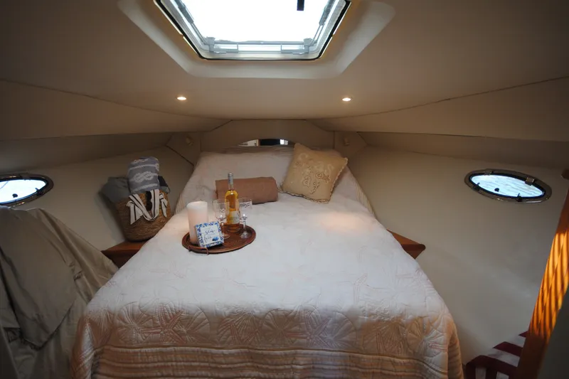 Slide: The Image of Cozy cabin interior of 2000 Silverton 351 Sedan with skylight and elegant bedding. - 19