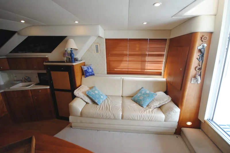Slide: The Image of Interior of 2000 Silverton 351 Sedan yacht with cozy seating and nautical decor. - 17