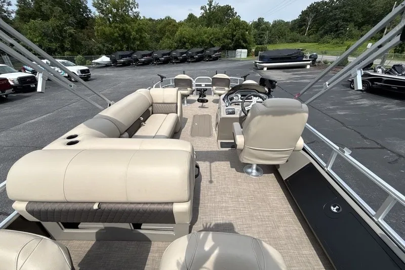 Slide: The Image of 2027 Sun Tracker Fishin' Barge 22 XP3 pontoon boat with spacious seating and modern controls. - 22