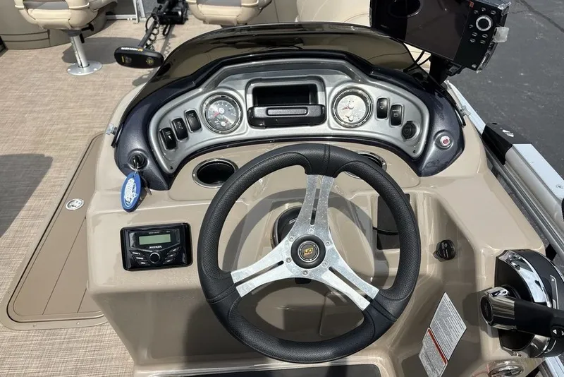 Slide: The Image of Steering console of 2027 Sun Tracker Fishin' Barge 22 XP3 with modern controls. - 24