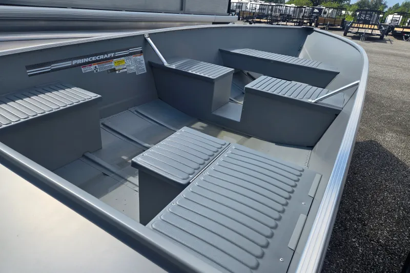 Slide: The Image of The image shows a gray aluminum boat with bench seating and an open interior. - 4
