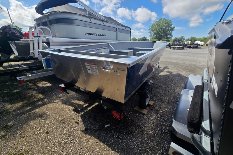 Slide: The Image of A 2026 Princecraft Yukon 14 L WT sits on a trailer in a parking lot. - 3