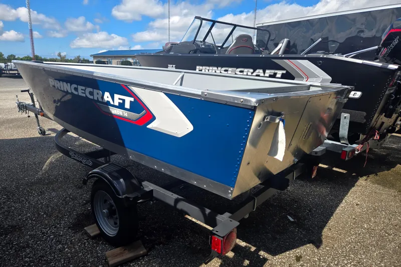 Slide: The Image of A blue Princecraft Yukon 14 L WT boat on a trailer, ready for transport. - 2