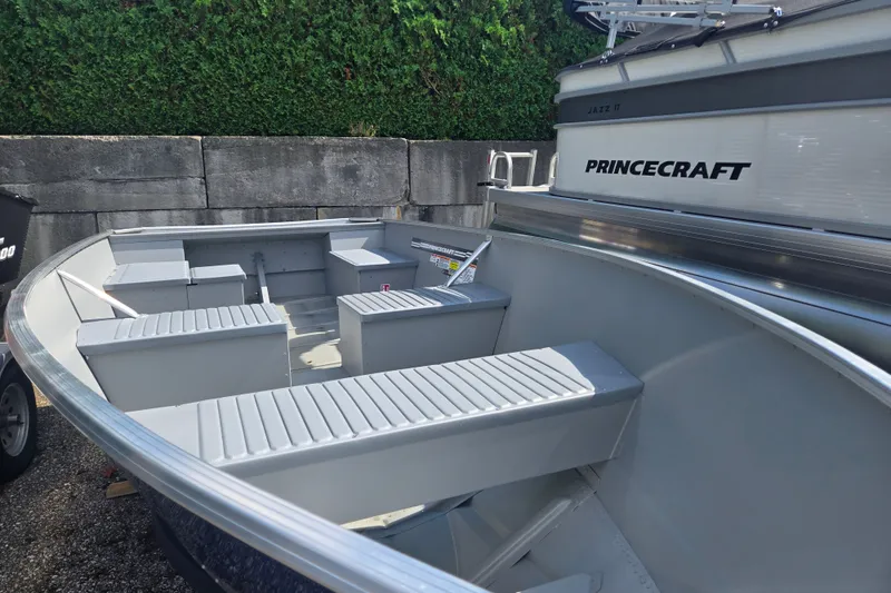 Slide: The Image of An open aluminum boat with bench seating and a clean, minimalist design. - 5