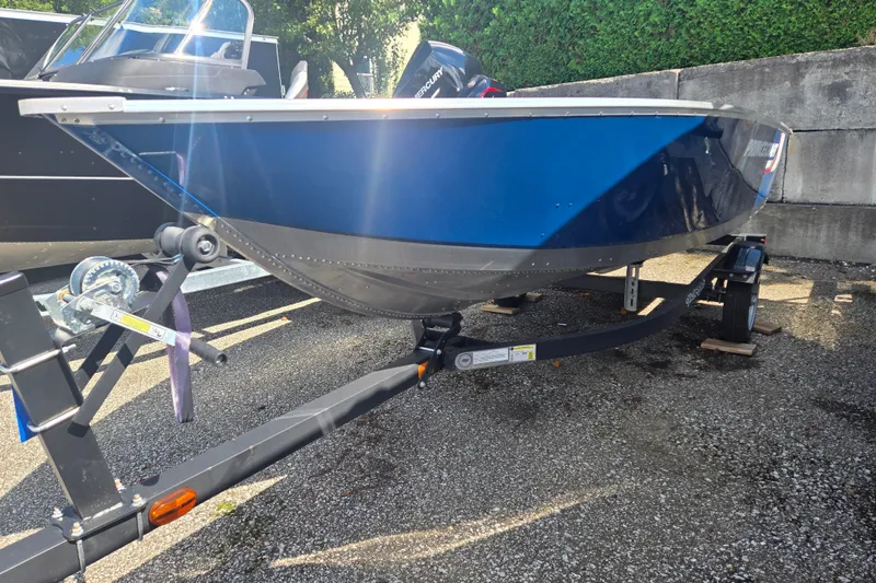 Slide: The Image of A blue boat on a trailer, with an outboard motor at the stern. - 1