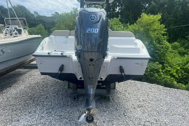 Slide: The Image of 2026 Key West 219 FS boat with Yamaha 200 engine, parked on gravel. - 2