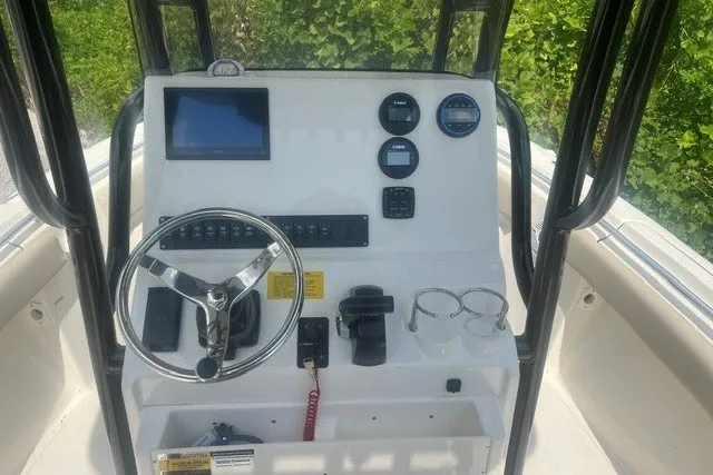 Slide: The Image of 2026 Key West 219 FS boat console with steering wheel, gauges, and electronic display. - 12