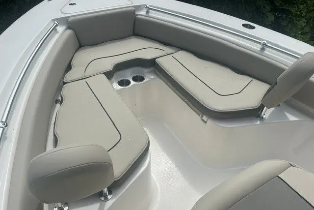 Slide: The Image of 2026 Key West 219 FS boat interior with beige cushioned seating and cup holders. - 4