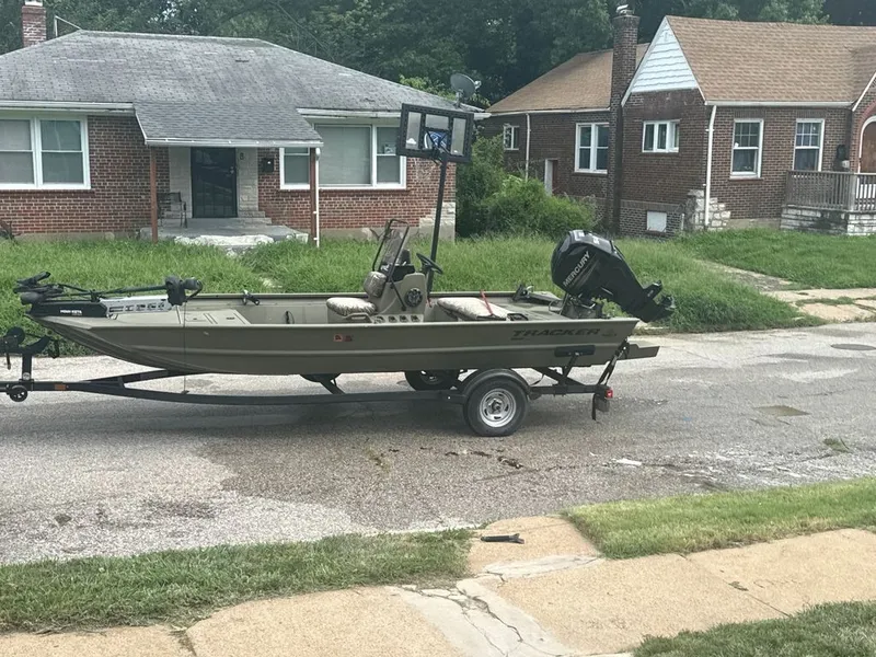 The Image of A 2019 Tracker Grizzly 1860 MVX CC on a trailer parked in front of a house. - 0