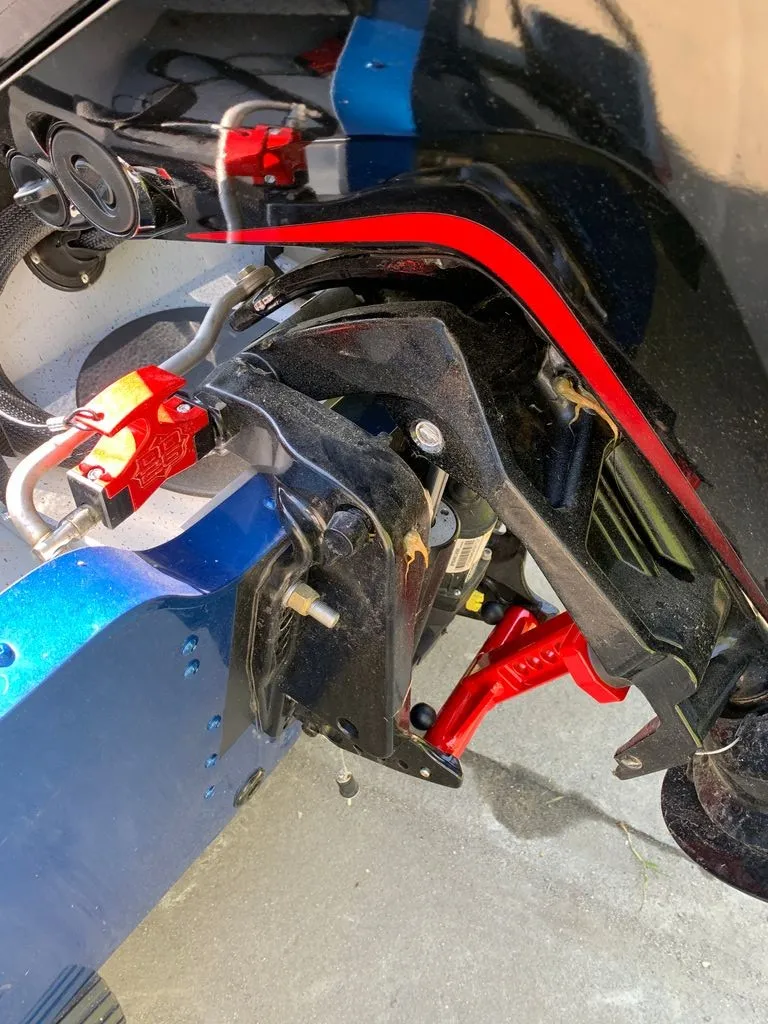 Slide: The Image of Close-up of a boat trailer with red and blue accents. - 14