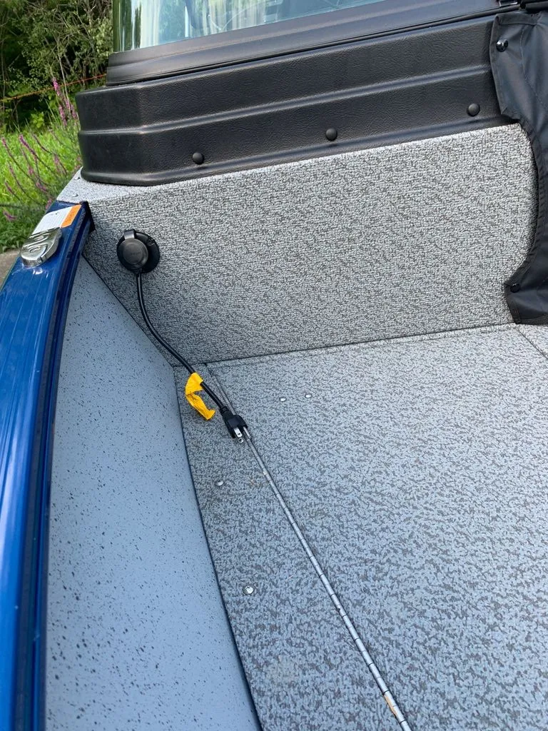 Slide: The Image of Interior view of a 2024 Lund 1775 Adventure Sport boat with gray flooring. - 7