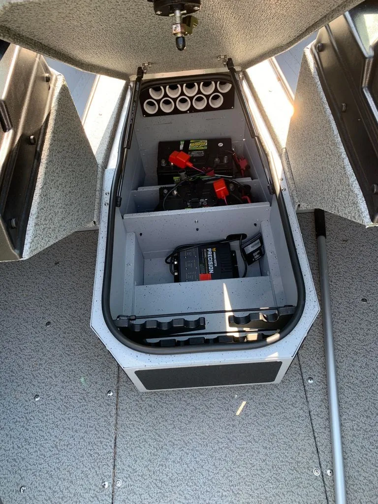 Slide: The Image of View inside a boat storage compartment with batteries and rod holders. - 4
