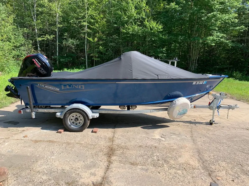 Slide: The Image of A blue 2024 Lund 1775 Adventure Sport sits on a trailer outdoors. - 17