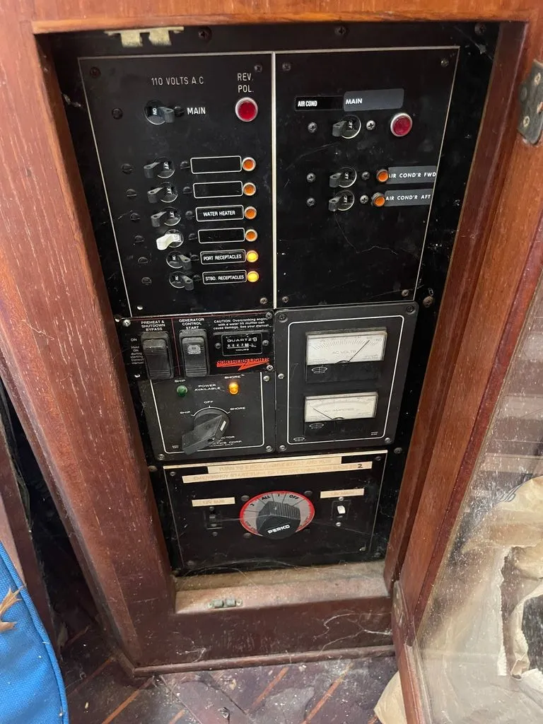 Slide: The Image of The image shows the electrical panel of a 1985 Catalina Morgan 43 with various switches and gauges. - 11
