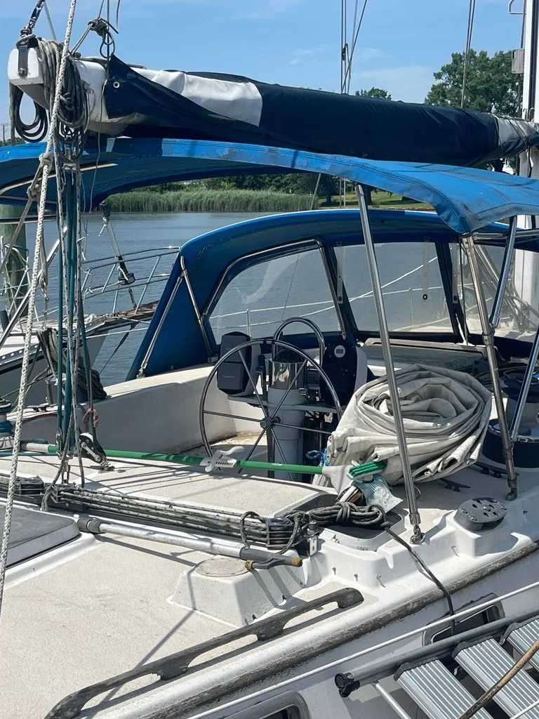 Slide: The Image of The image shows the cockpit of a 1985 Catalina Morgan 43 with a blue cover. - 4