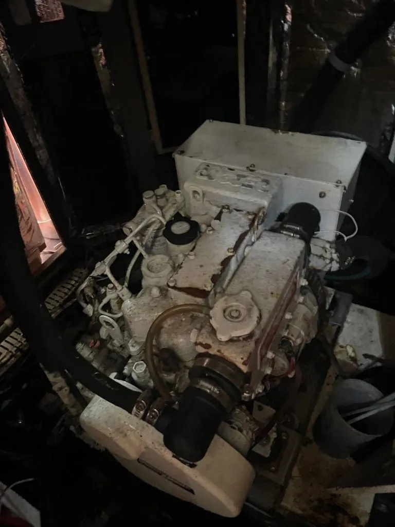 Slide: The Image of An engine in a 1985 Catalina Morgan 43, surrounded by hoses and cables. - 15