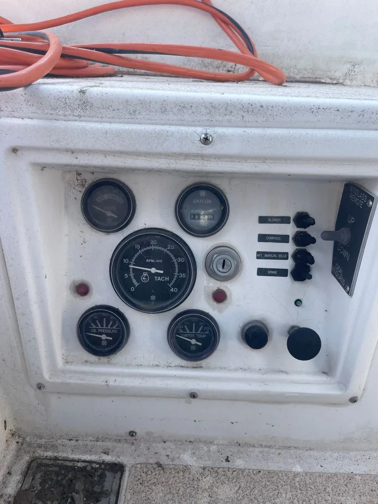 Slide: The Image of Dashboard of a 1985 Catalina Morgan 43 with various gauges and switches. - 12