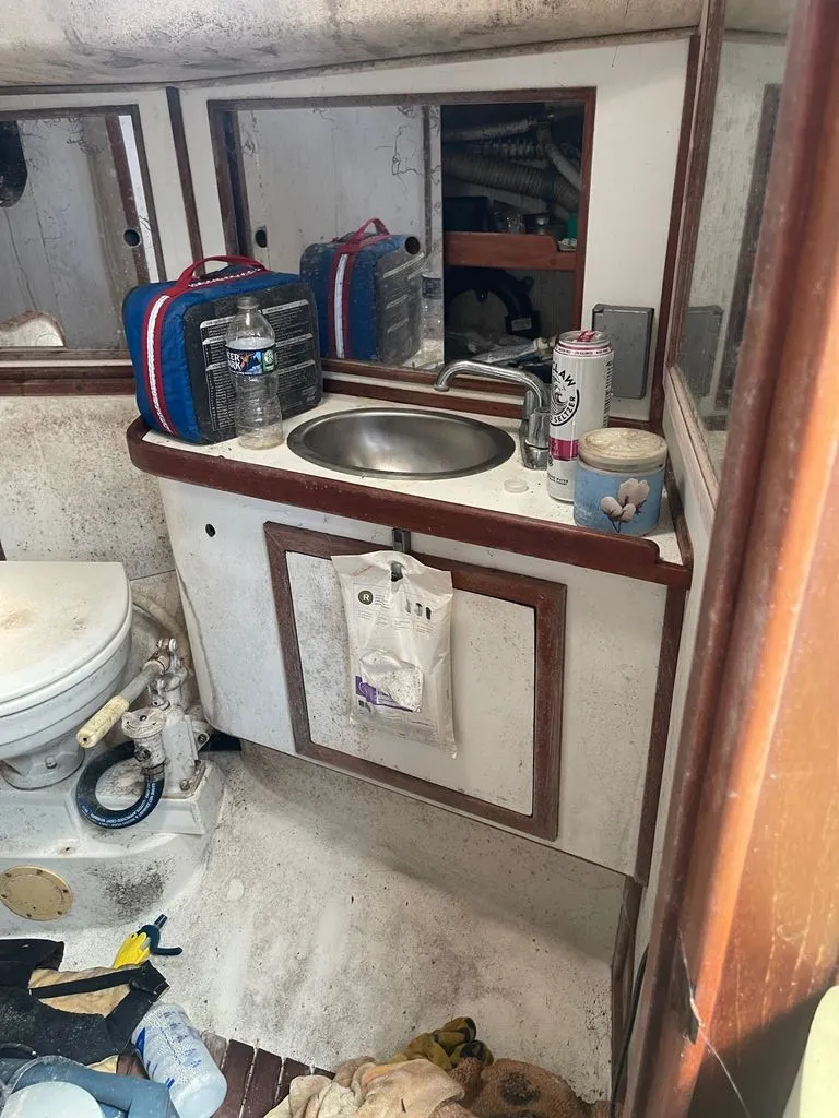 Slide: The Image of The image shows a boat bathroom with a sink, toilet, and mirror. - 9