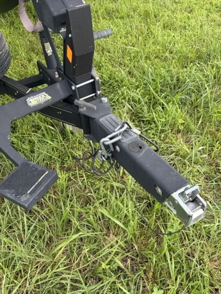Slide: The Image of Close-up of a trailer hitch on a green grassy field. - 27