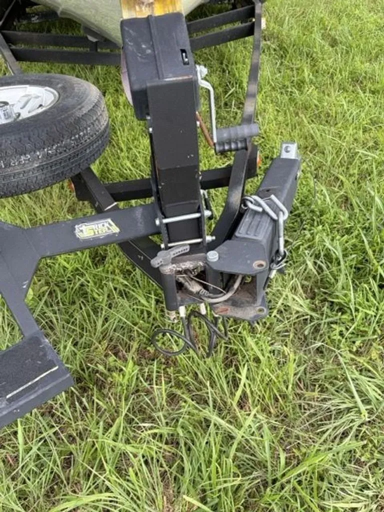 Slide: The Image of Close-up of a boat trailer on grass with spare tire and hitch. - 28