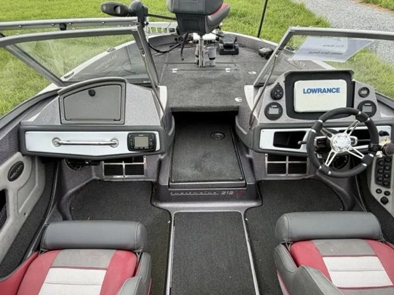 Slide: The Image of The image shows the cockpit of a 2012 Ranger 212LS Reata boat with modern instruments. - 13