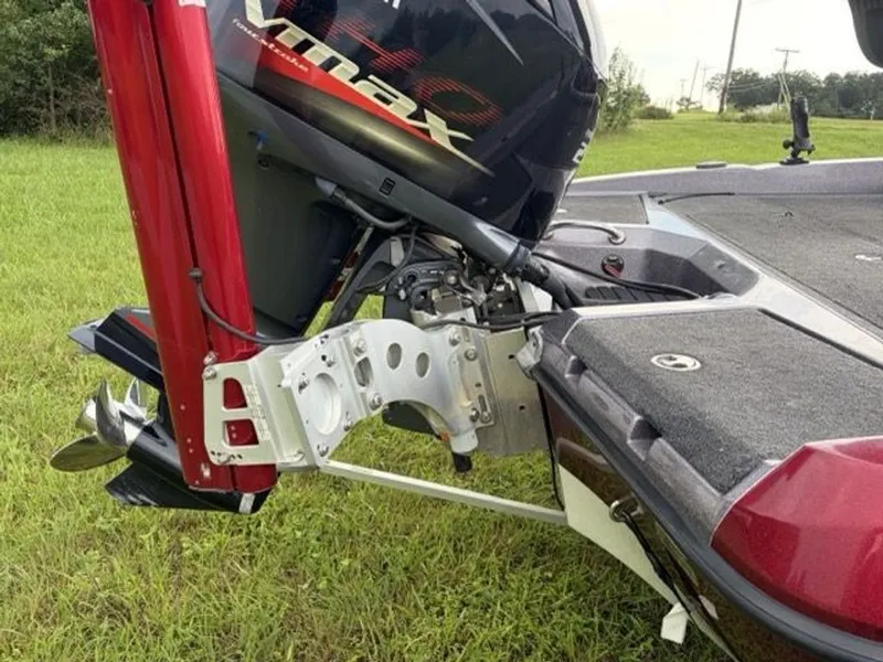 Slide: The Image of A red Ranger boat with a Yamaha outboard motor on a grassy field. - 24
