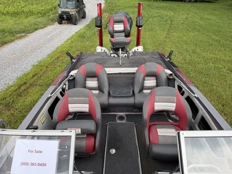 Slide: The Image of The image shows a 2012 Ranger 212LS Reata boat with red and gray seating. - 14