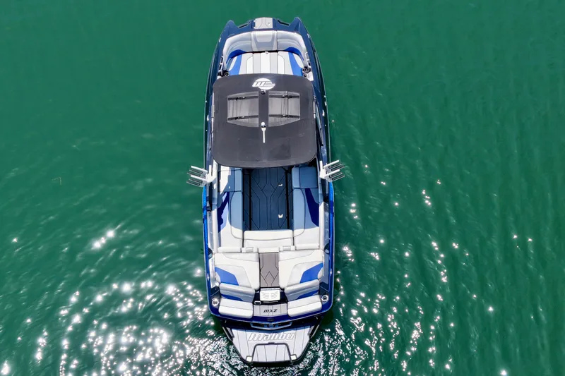 Slide: The Image of Aerial view of 2020 Malibu Wakesetter 24 MXZ on sparkling green water. - 38