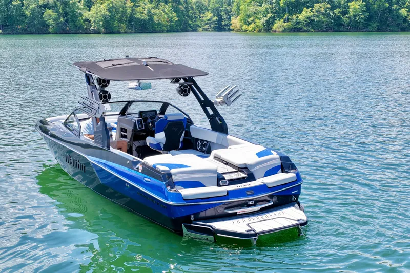 Slide: The Image of 2020 Malibu Wakesetter 24 MXZ boat on a serene lake. - 5