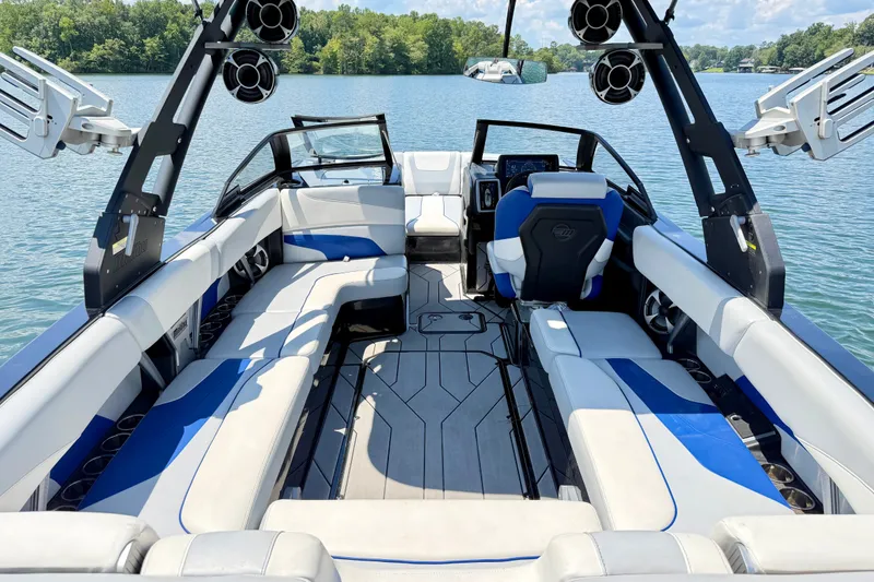 Slide: The Image of 2020 Malibu Wakesetter 24 MXZ boat interior with spacious seating and modern design on a lake. - 12