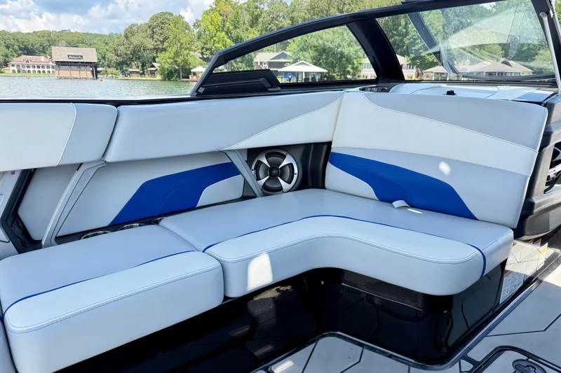 Slide: The Image of Interior of 2020 Malibu Wakesetter 24 MXZ boat with blue and white seating. - 24