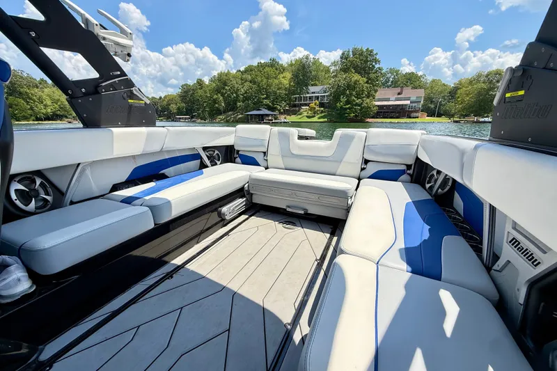 Slide: The Image of 2020 Malibu Wakesetter 24 MXZ interior with spacious seating, lake view, and clear sky. - 31
