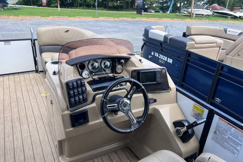 Slide: The Image of 2024 Starcraft SLS 3 boat dashboard with steering wheel and control panel. - 5