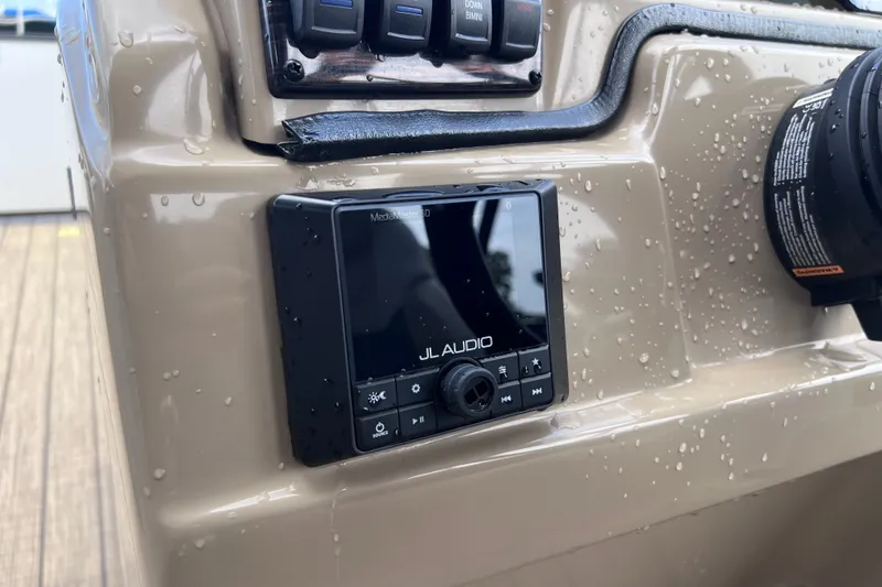 Slide: The Image of Control panel of 2024 Starcraft SLS 3 boat with JL Audio system. - 13