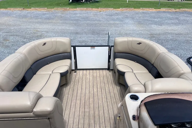 Slide: The Image of 2024 Starcraft SLS 3 pontoon boat interior with beige seating and spacious layout. - 4