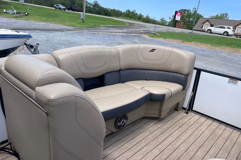 Slide: The Image of 2024 Starcraft SLS 3 boat interior with beige and gray seating on a wooden deck. - 10