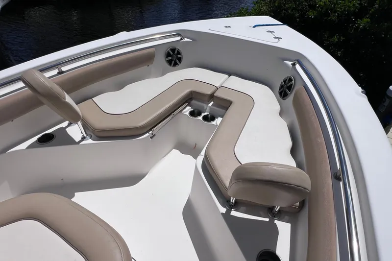 Slide: The Image of 2016 Key West 203 FS boat interior with cushioned seating and cup holders. - 17
