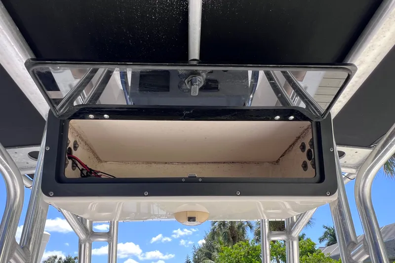 Slide: The Image of Open storage compartment on a 2016 Key West 203 FS boat, under a clear blue sky. - 26