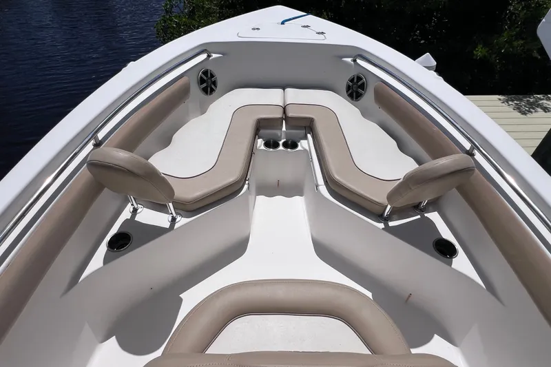 Slide: The Image of 2016 Key West 203 FS boat interior with cushioned seating and cup holders. - 15