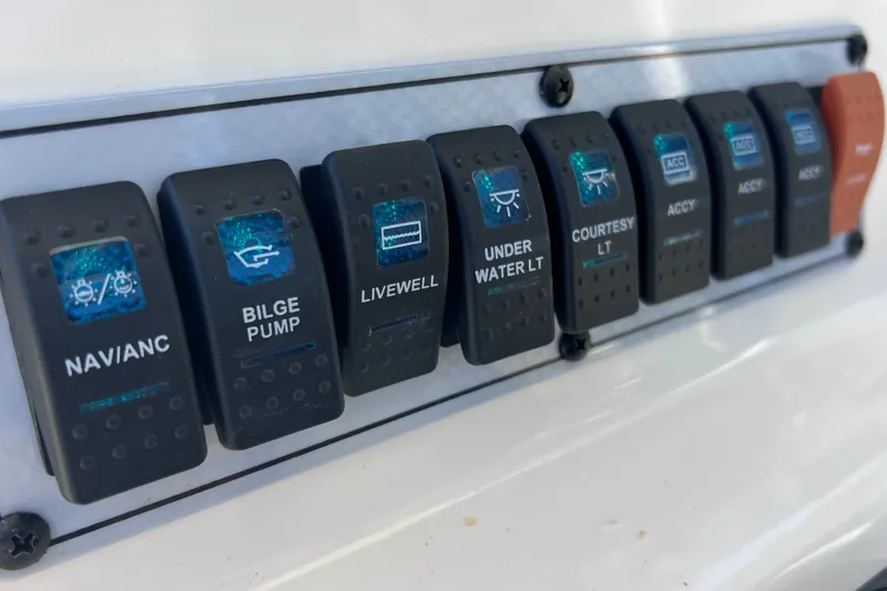 Slide: The Image of Control panel of a 2016 Key West 203 FS boat with labeled switches. - 31
