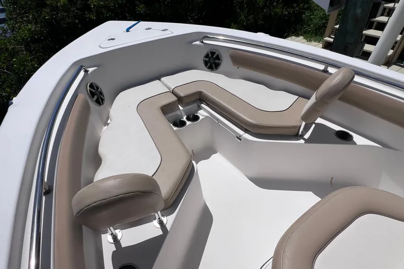 Slide: The Image of 2016 Key West 203 FS boat interior with cushioned seating and cup holders. - 16
