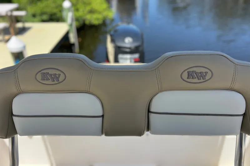 Slide: The Image of 2016 Key West 203 FS boat seats with KW logo, overlooking water and dock. - 14