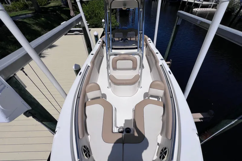 Slide: The Image of 2016 Key West 203 FS boat interior with beige seating, docked by a wooden pier. - 18