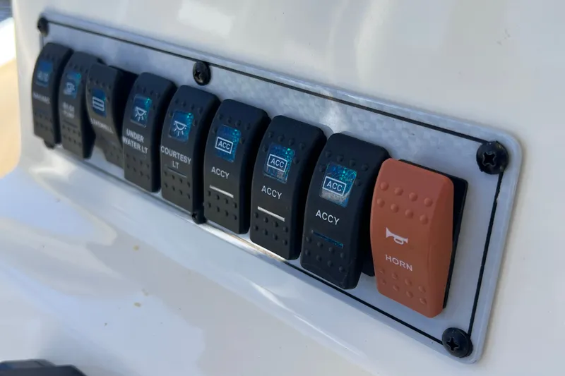Slide: The Image of Control panel of a 2016 Key West 203 FS boat with labeled switches. - 30