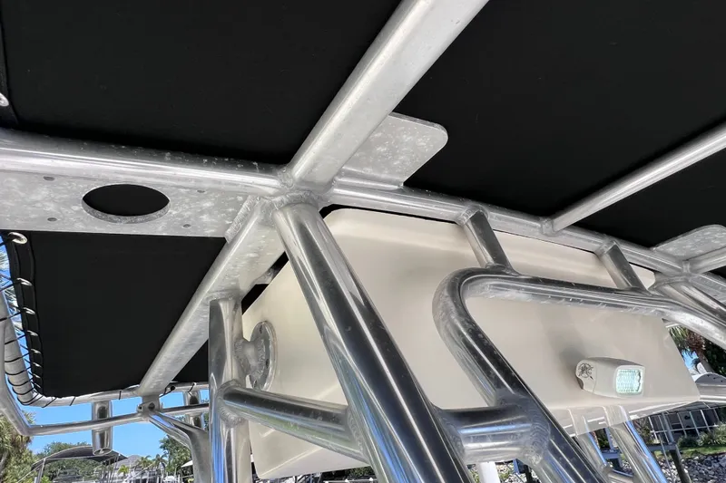 Slide: The Image of 2016 Key West 203 FS boat T-top frame with black canvas and light fixture. - 25
