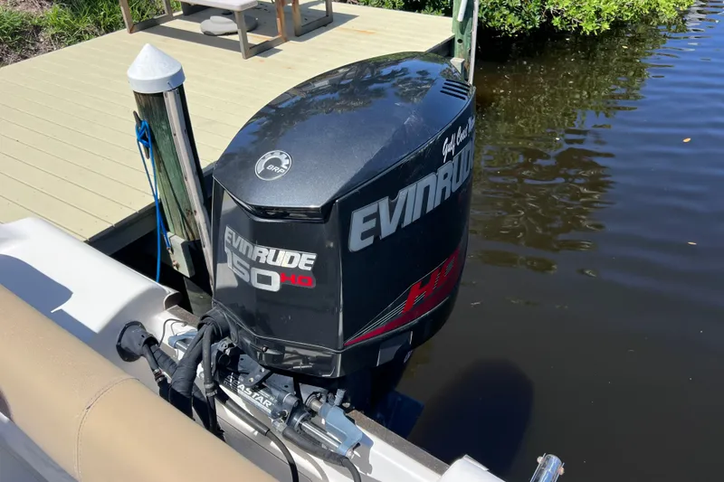 Slide: The Image of Evinrude 150 HP outboard motor on 2016 Key West 203 FS boat by a dock. - 42