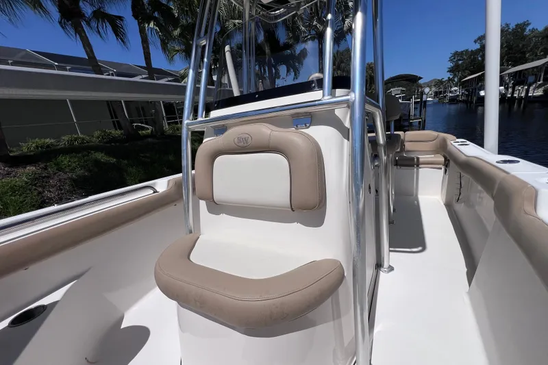 Slide: The Image of 2016 Key West 203 FS boat interior with beige seating and stainless steel frame. - 19