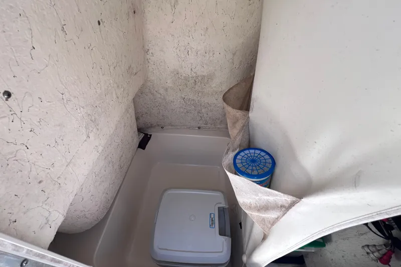 Slide: The Image of Interior storage compartment of a 2016 Key West 203 FS boat with cooler and container. - 35