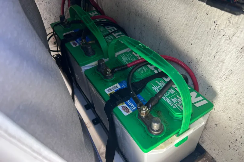 Slide: The Image of Dual marine batteries in a 2016 Key West 203 FS boat, secured with green straps. - 36